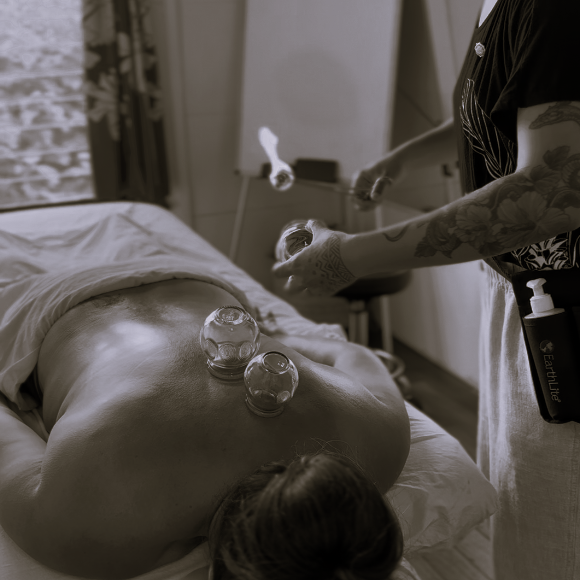 Melody performing bentusa, fire cupping, on a client